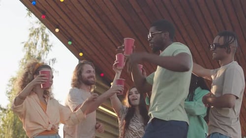 Happy Young Adults Dancing at Party