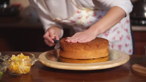 Close Up Shot of a Woman's Hands That Cuts a Freshly Baked Cake Into Pieces