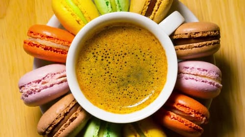 Macaroon cookies and coffee cup rotates