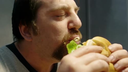 Man Eating Burger Close-Up Indoor