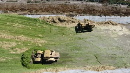 Tractors Spreading Grass for Silage from Aerial View