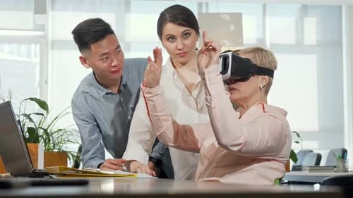 Woman Using VR Headset with Colleagues in Office