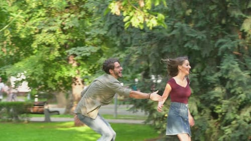 Young Couple Running and Embracing in the Park