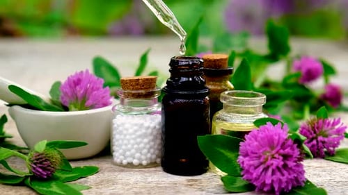 Natural Herbal Medicine Drops Into Bottle