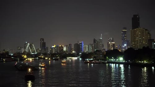 Night City Traffic on River Along Bangkok Downtown, Thailand