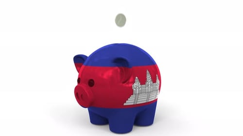 Coins Fall Into Piggy Bank Painted with Flag of Cambodia