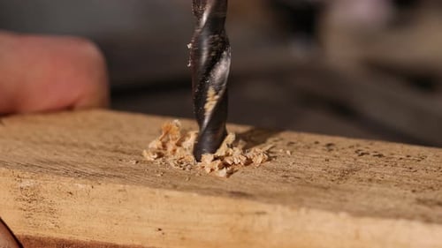 Drill Bit Drilling Into Wood Close Up