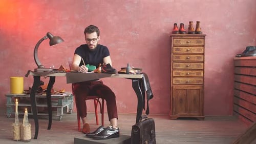 Bearded Craftsman Designing Footwear in Workshop