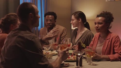 Friends Enjoying Dinner and Drinks at Night