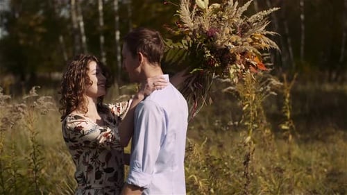 Young Couple Walking on a Meadow