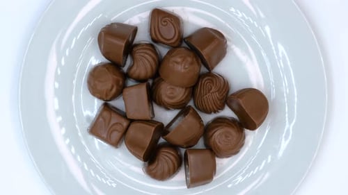 Chocolate candies on a white plate