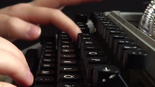 The girl is typing on a retro typewriter.