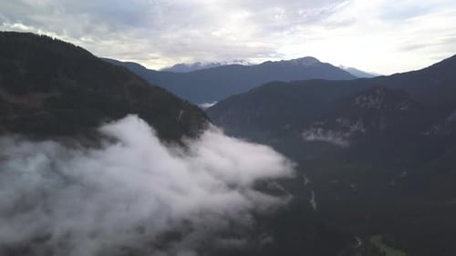 AERIAL: Scenic Mountain View with Forest and Snow in the Background, Winter