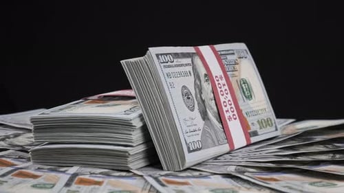 Stacks of Hundred Dollar Bills on Black Background