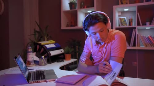 Young Adult Studying at Desk at Night