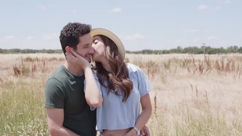 Romantic couple kissing in field