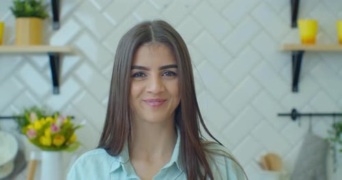Smiling Woman with Long Hair in Modern Kitchen