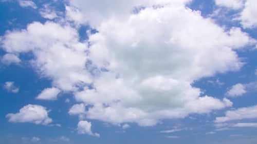 White Clouds Drifting Across a Clear Blue Sky