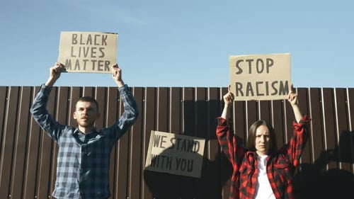 Demonstrators Holding Protest Signs for Equality