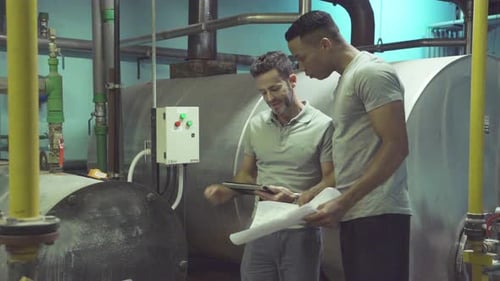 Industrial plant workers at work