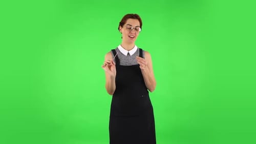 Funny Girl in Round Glasses Is Making Herself Manicure with Pink Nail File. Green Screen