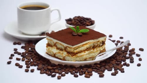 Traditional Tiramisu Dessert Square Portion and Cup of Fresh Espresso Coffee Isolated on White