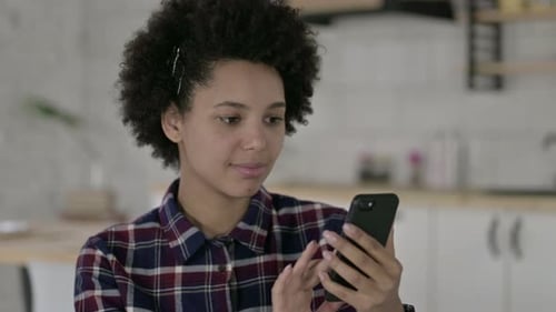 Woman Using Smartphone in Bright Home Interior