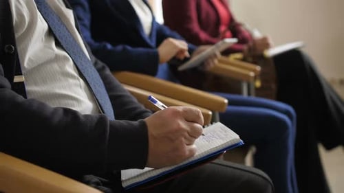 Business People Taking Notes in Corporate Setting