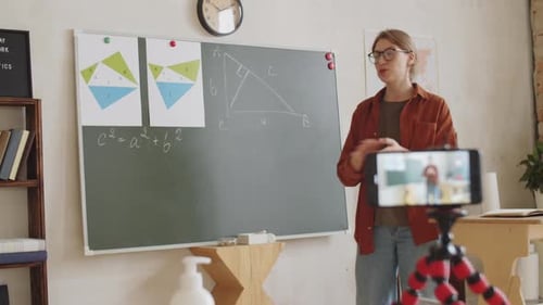 Female Teacher Giving Live Video Lesson from School Classroom