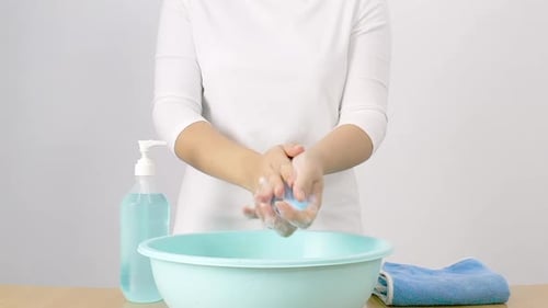 Person Thoroughly Washing Hands with Soap and Water