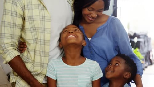 Smiling Family Embraces in Bright Home Setting