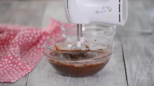 Chocolate Mixture Being Mixed in Glass Bowl