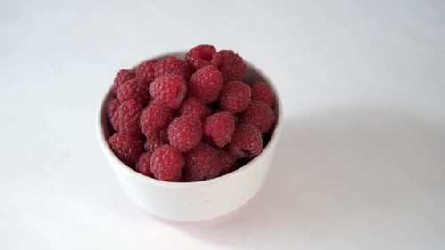 Fresh Raspberries in White Bowl Close Up