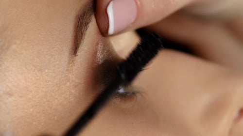 Applying Black Mascara to Long Eyelashes