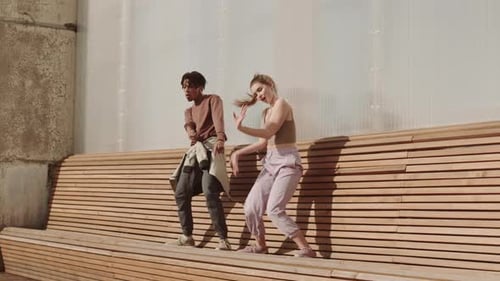 Multiethnic Performers Dancing on Wooden Bench