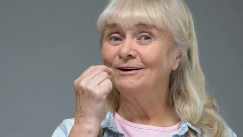 Senior Woman Taking Pill and Drinking Water