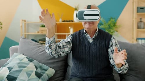 Mature Adult Using VR Headset on Couch