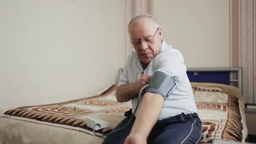 Senior Man Checking Blood Pressure at Home