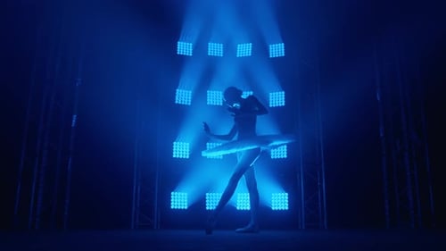 Woman Ballet Dancer Performance Under Blue Stage Lights
