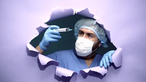 Man in Medical Mask Holding Syringe