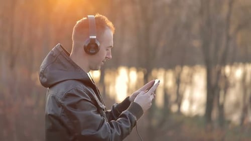 Man Uses Phone in the Park