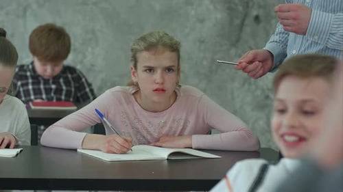 Children Working at Desks in Classroom