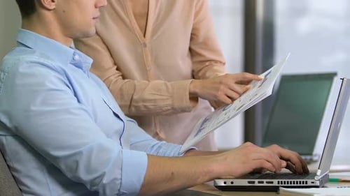 Man and Woman Working Together on Computer
