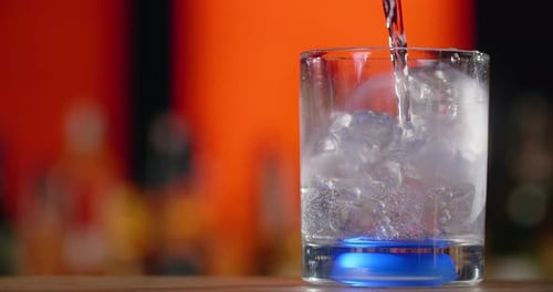 Refreshing Drink Poured into Glass with Ice