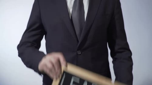 Leader Written on Blackboard, Businessperson Holding Sign, Business Concept