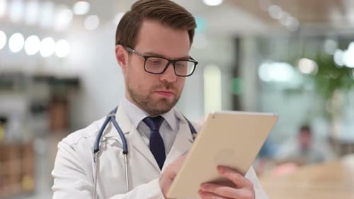 Doctor Using Tablet in Hospital Office