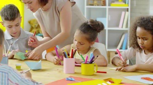 Children Crafting Together in Classroom with Teacher