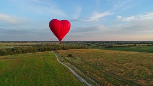 Heart-Shaped Balloon Flying Over Green Fields