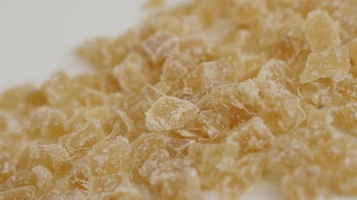 Close-up pile of Candied ginger root on the table slow tilt 4K 2160p 30fps UltraHD footage - Crysta