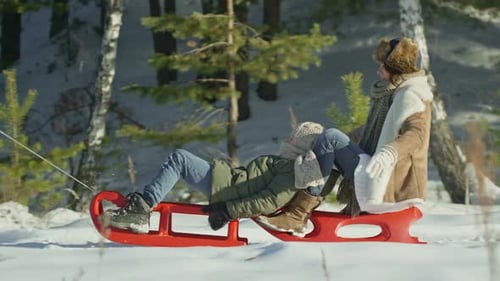 Happy Parents Pulling Sleds with Son